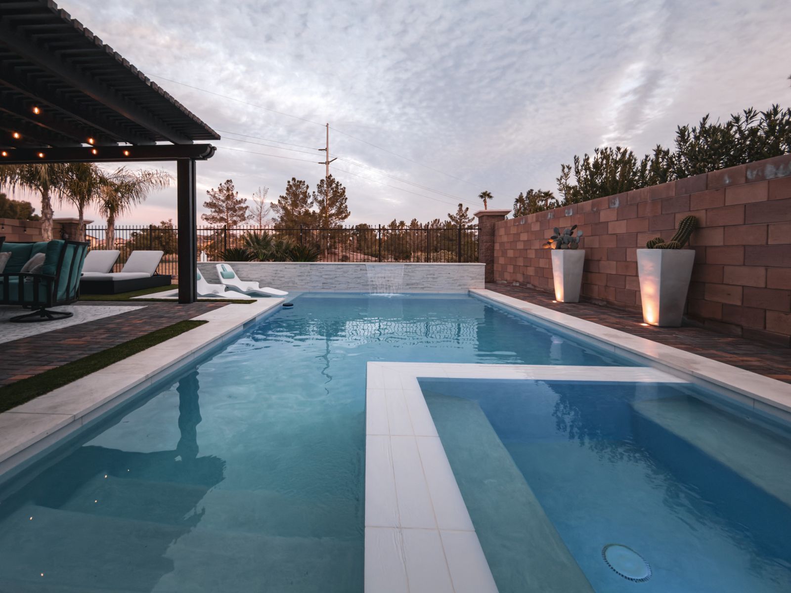 Pool and outdoor lounge with fire tables at twilight — Pools R Us Arizona